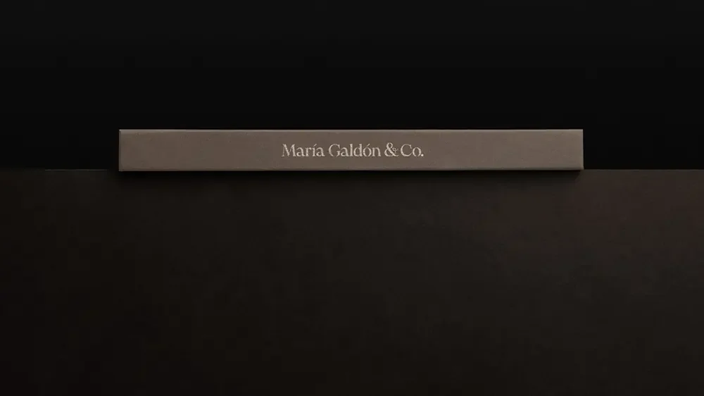 A linen presentation case stamped with the wordmark.